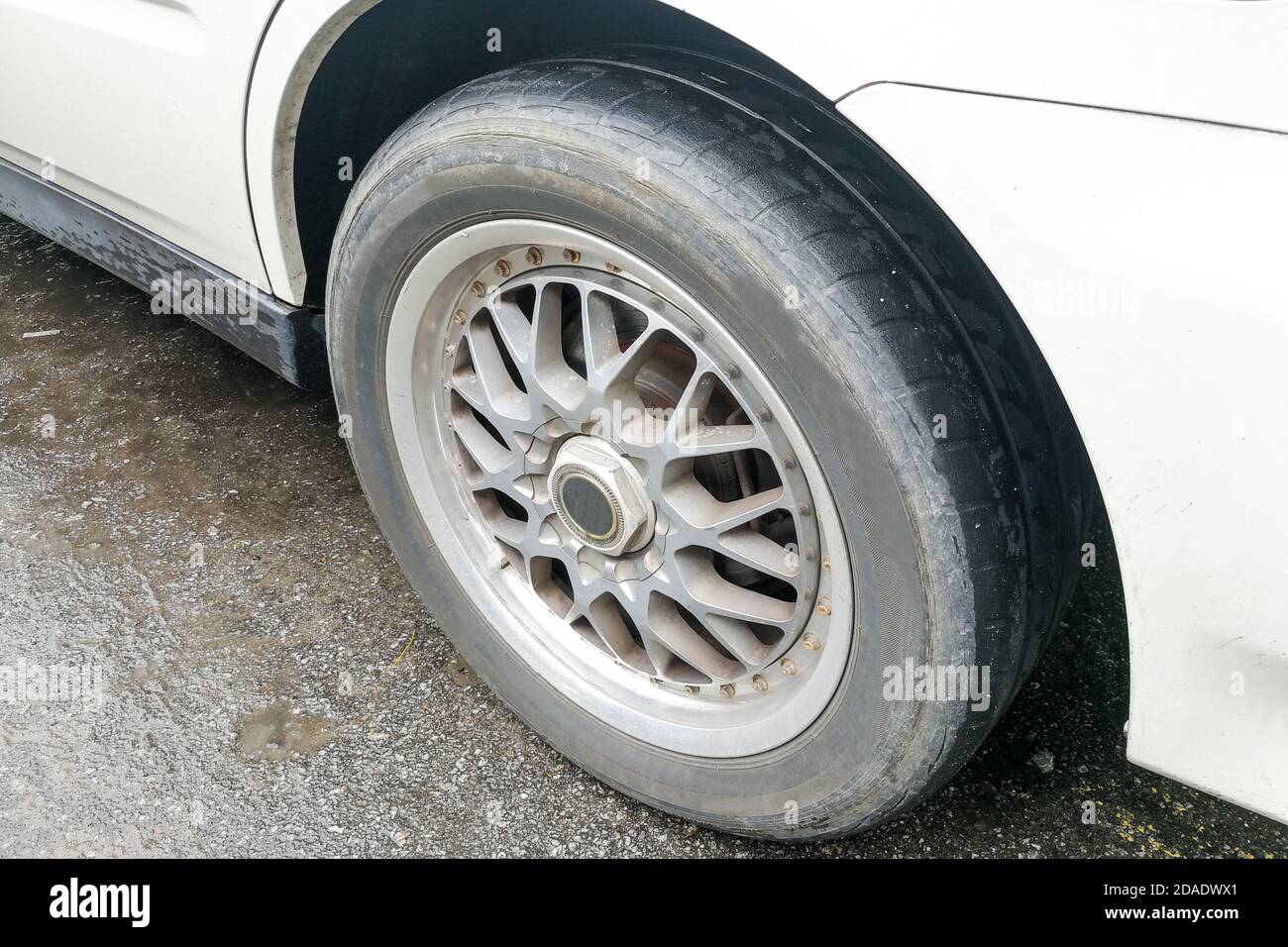 Car with worn bald tire unsafe and poses accident risk Stock Photo Alamy