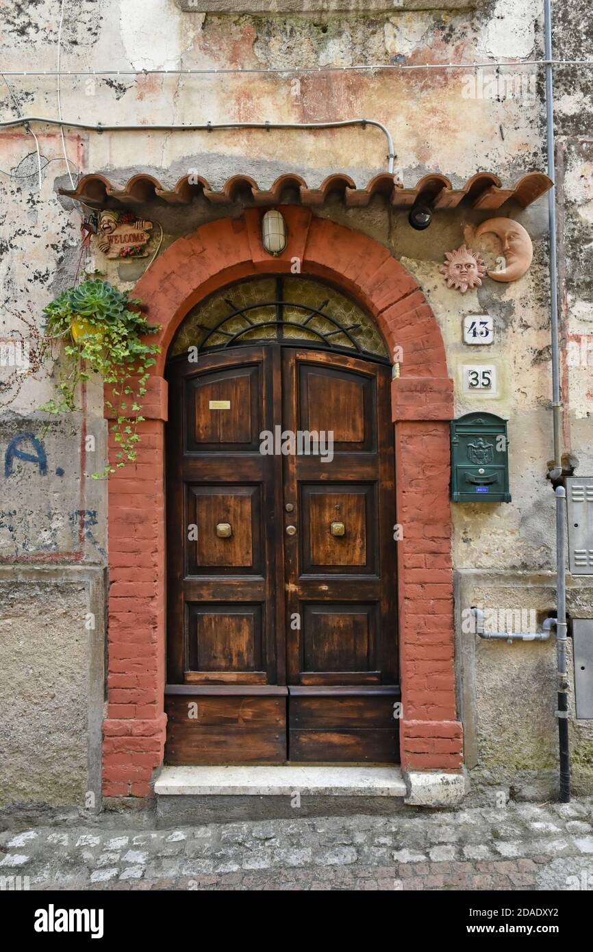 The facade of an old house in Lenola, a medieval village in the mountains of the Lazio region, Italy. Stock Photo