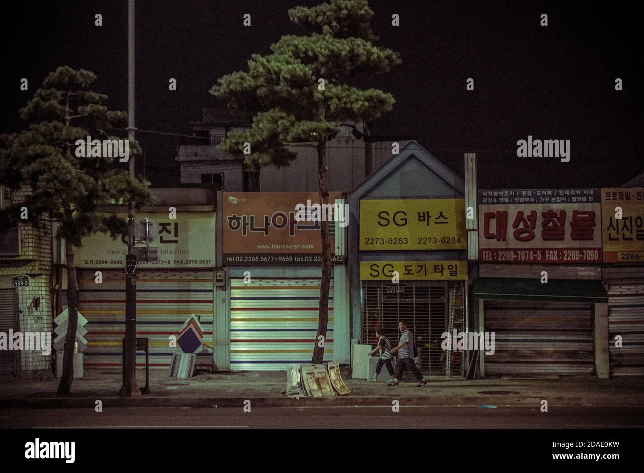 korean couple walking in seoul street at night Stock Photo