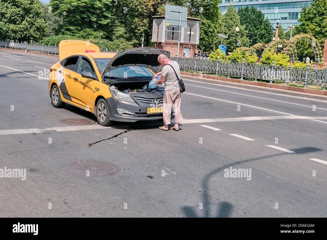 Moscow Russia 06 10 2019: Driver Yandex Taxi Saves Pouring Water.