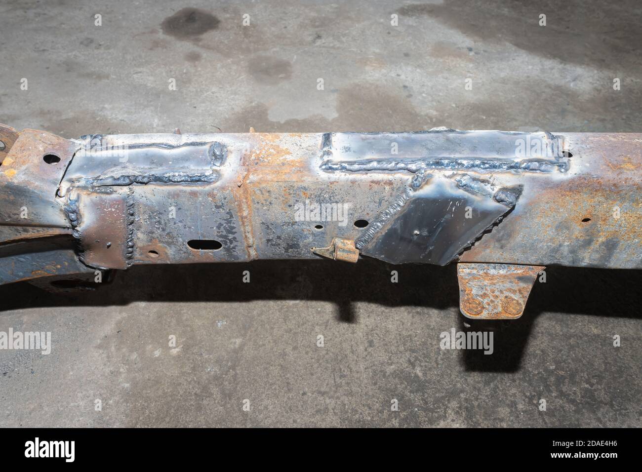 Repairing Car Chassis by Electrode Arc Welding in Car Repair Shop in