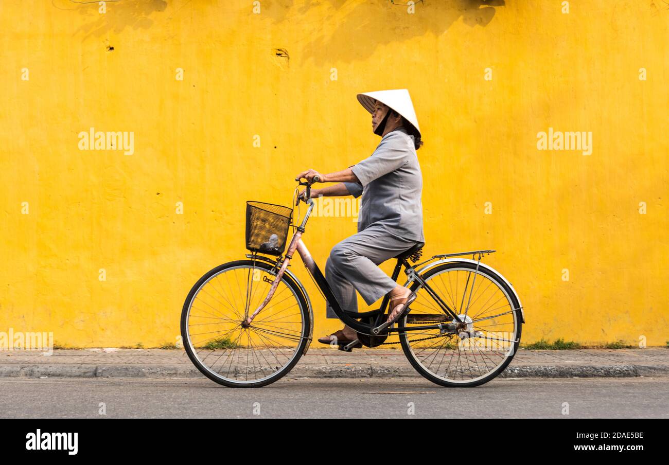 Hoi An Ancient Town, Vietnam, January 27, 2020 Woman riding a bicycle