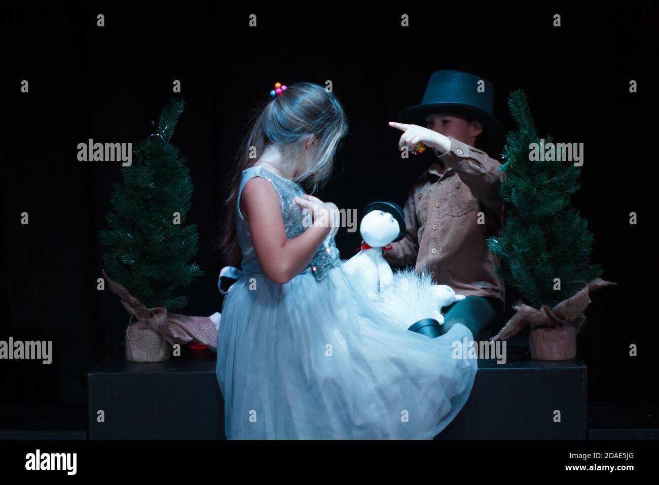 Moscow region / Russia - 01 06 2019: Puppet theater with Moomin trolls. Boy and girl playing with Moomin Troll dolls. Performance with family Moomins Stock Photo