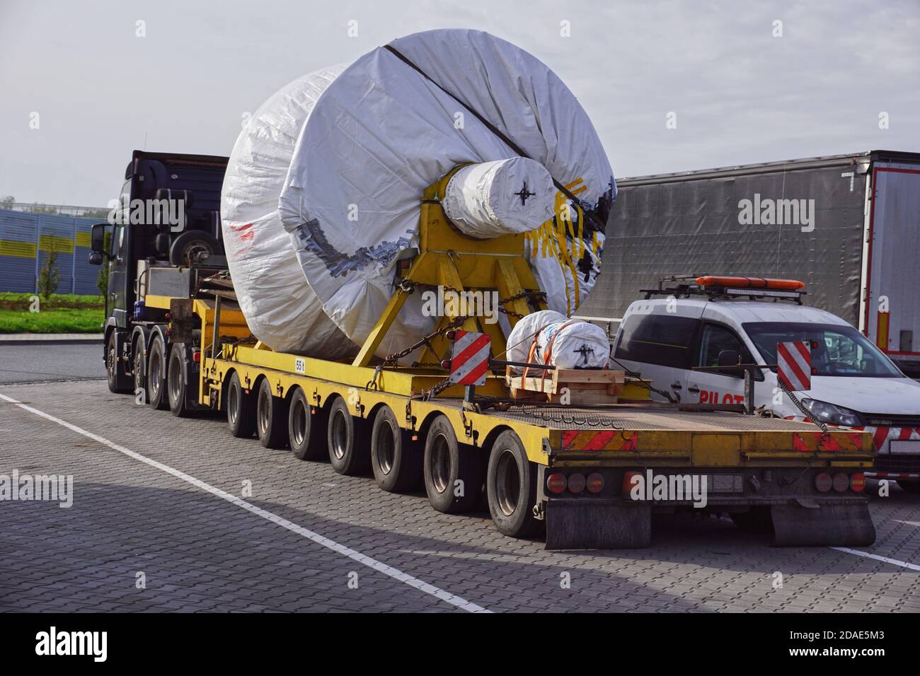 A trucks with a special semi-trailers for transporting oversized loads. Oversize load or exceptional convoy. Stock Photo