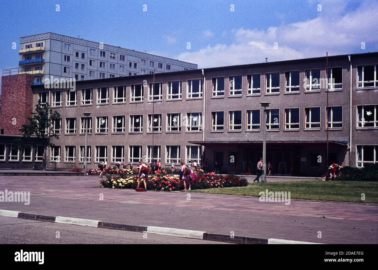 Children outside  a school in Berlin in 1965.Slide taken on Agfacoulour CT18 slide film using a 35mm  Petri 5 SLR.Digitally copied using a Nikon D7500 Stock Photo
