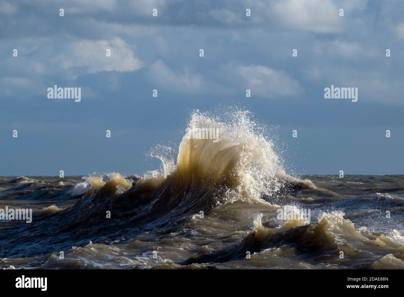 Stormy waves, backlit by low sunshine, in the English Channel on a ...