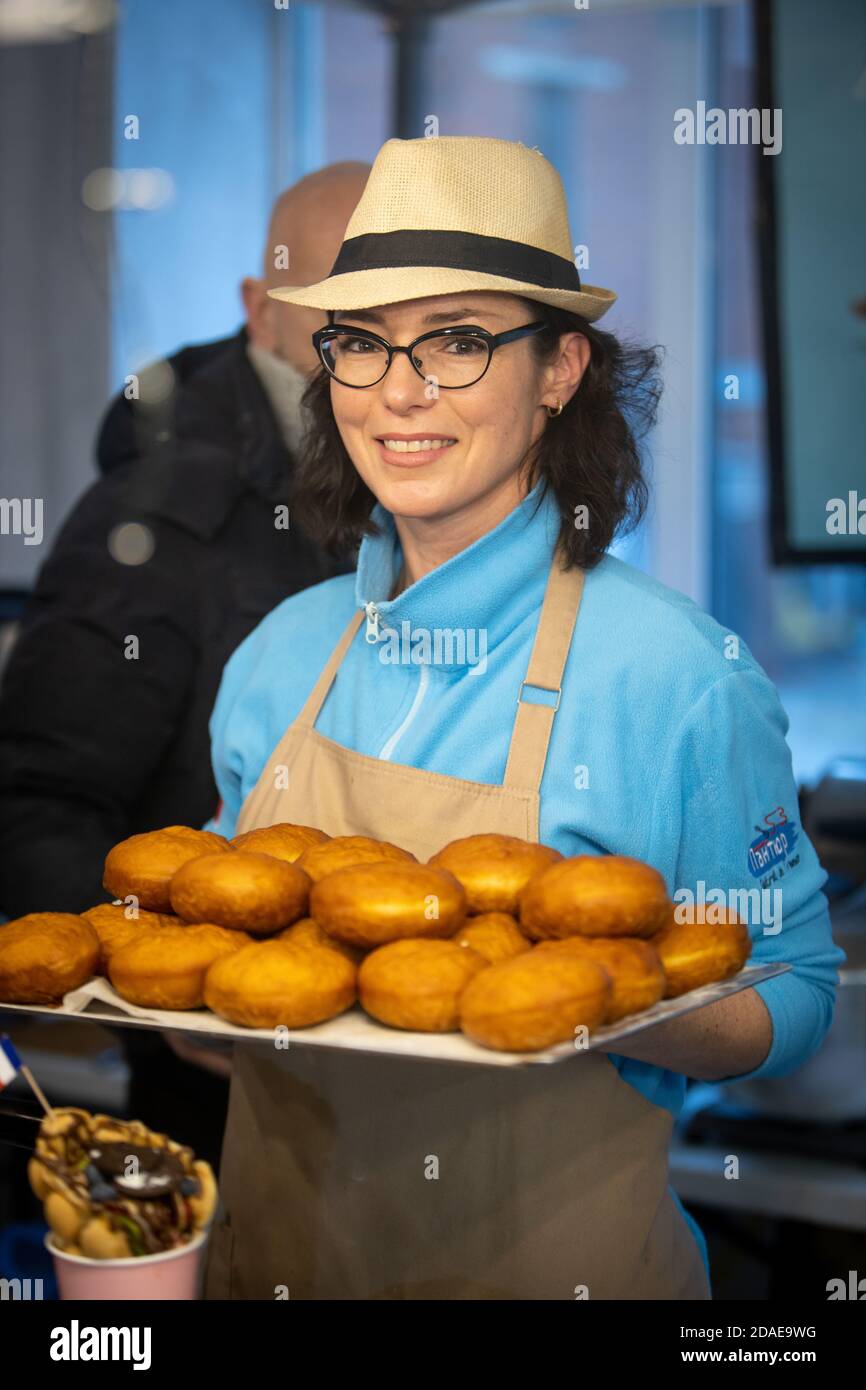 Woman with glasses sells doughnuts in a store: Russia. Moscow 20 December 2019 Stock Photo