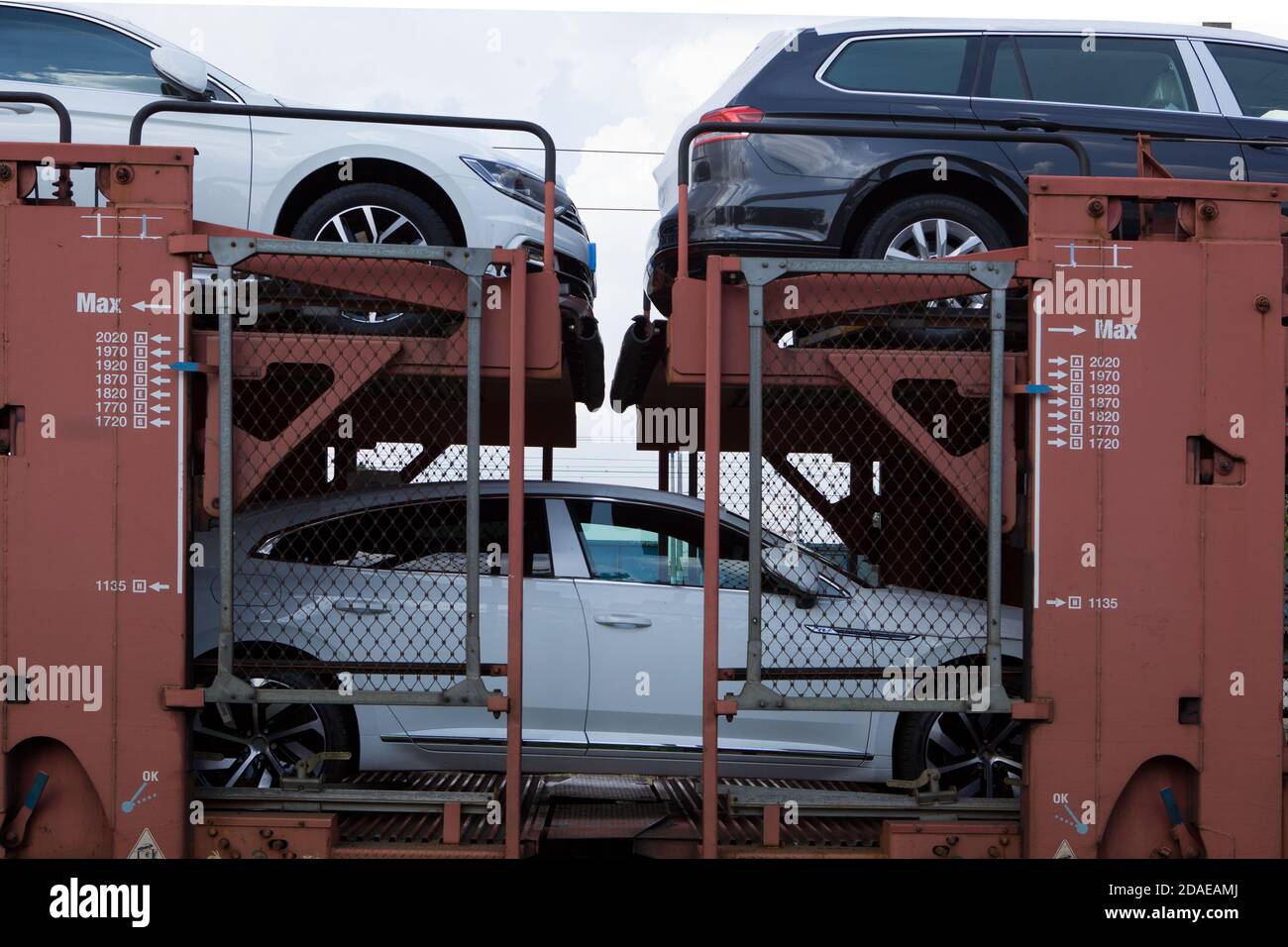 Poznan, Poland - May 17, 2019: New cars transported with railway platforms. Cars transported by train. Stock Photo