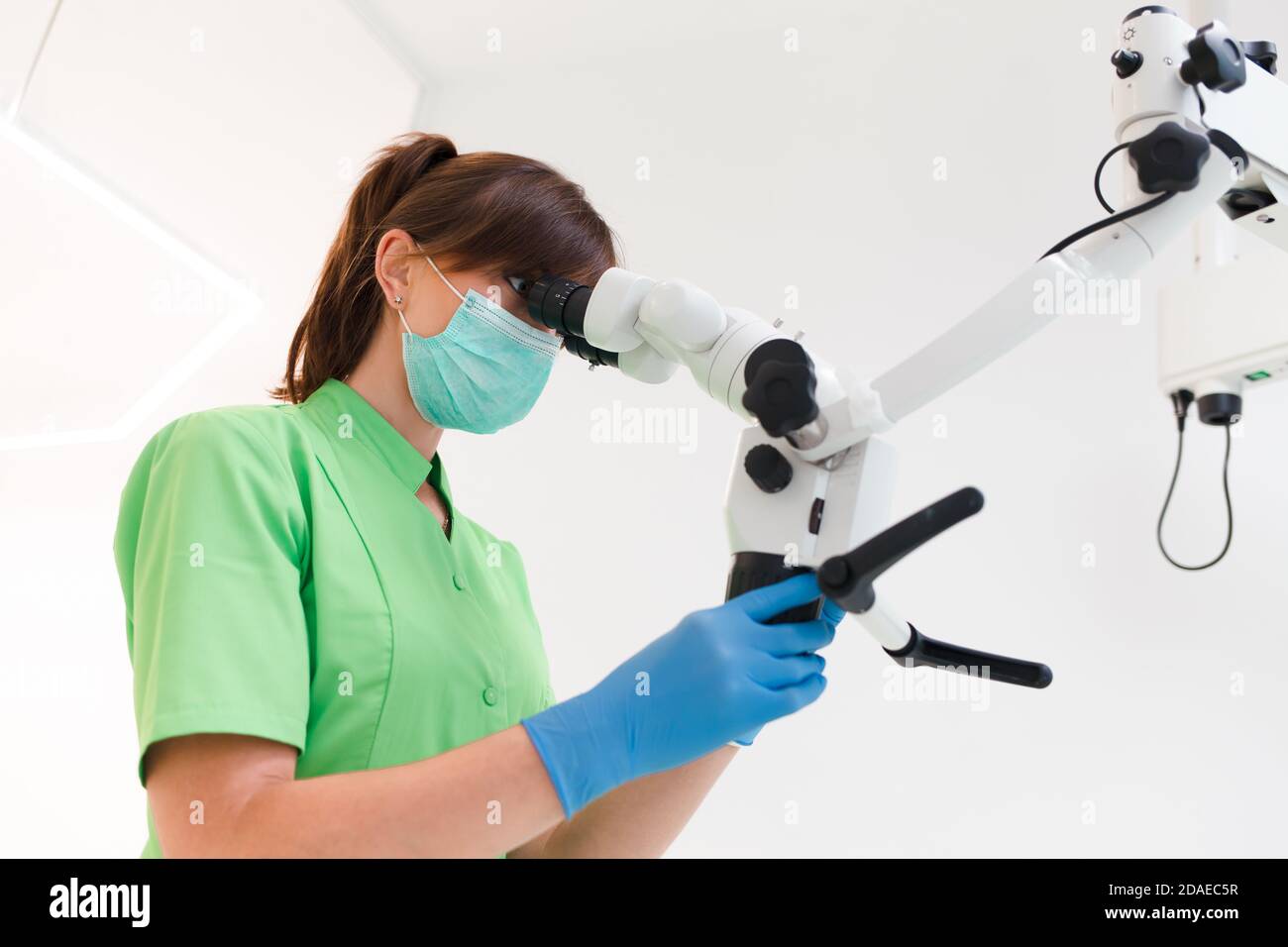 Dentist doctor using dental microscope Stock Photo