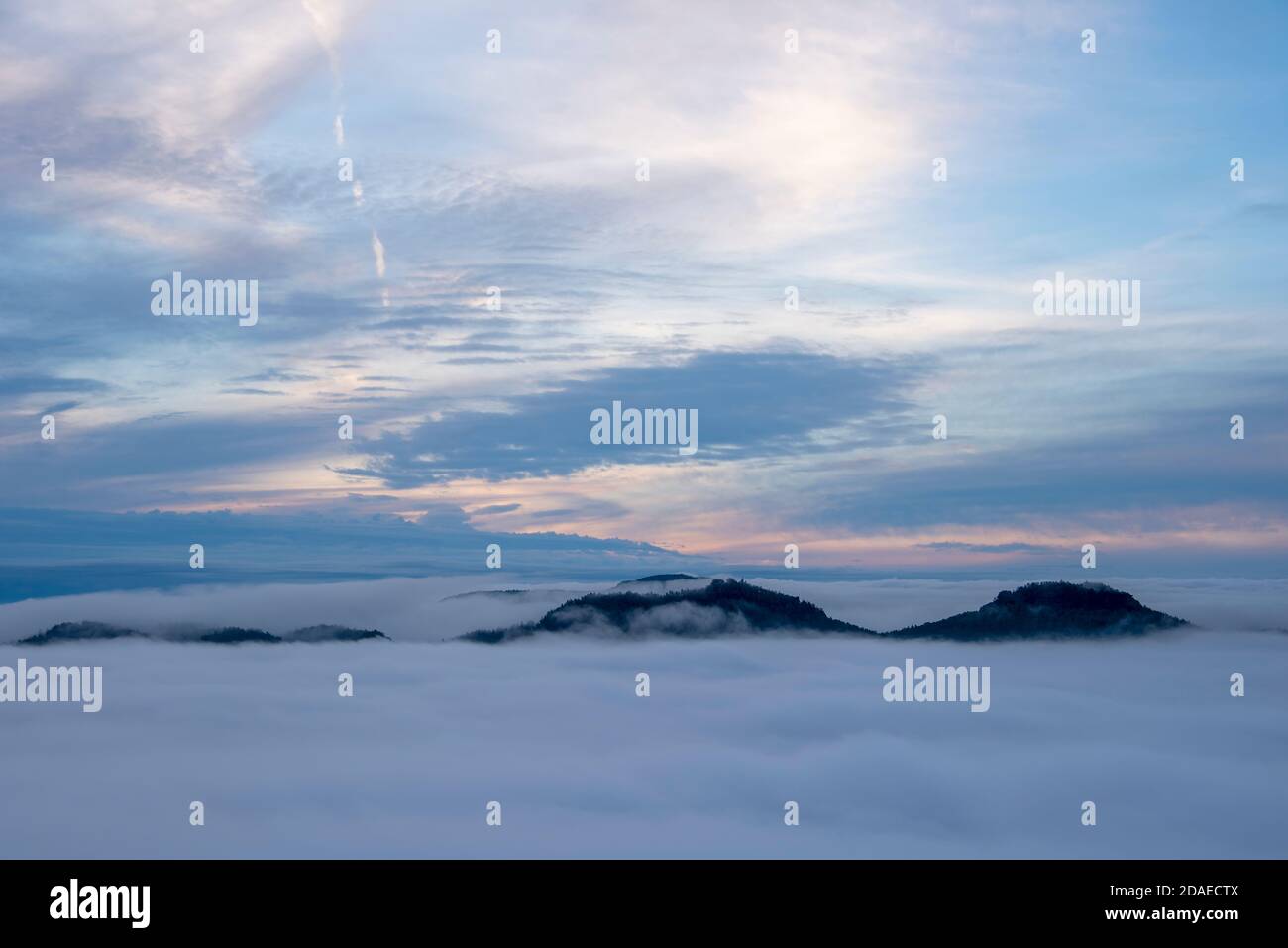 Germany, Saxony, view from Lilienstein, thick clouds of fog pull over the Elbe Sandstone Mountains shortly after sunrise Stock Photo
