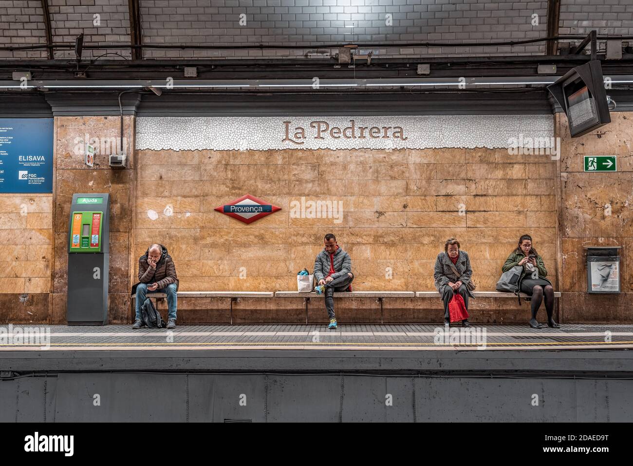 Barcelona, Spain - Feb 24, 2020: People wait at Provenca metro station at night Stock Photo