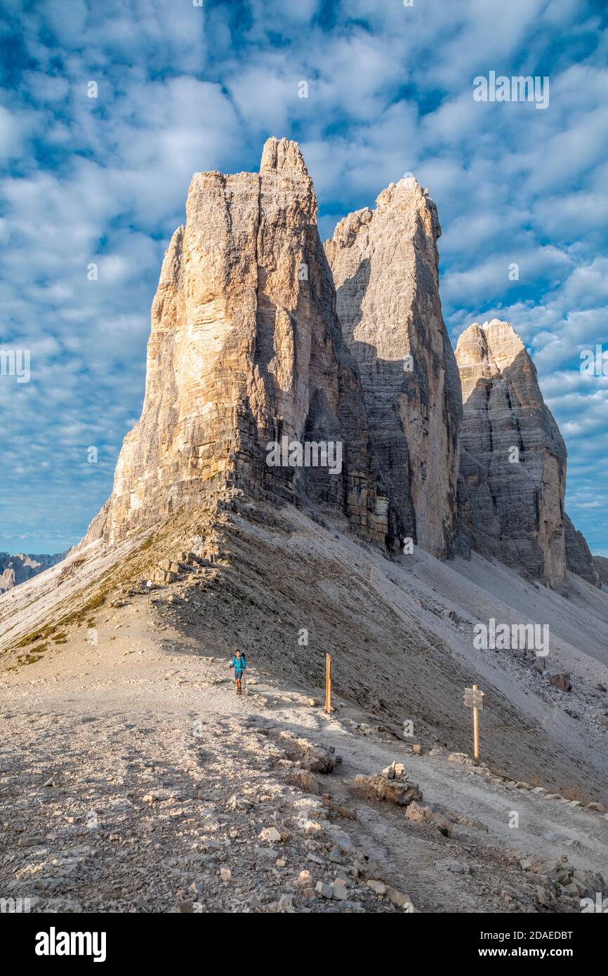 lonely hiker at the lavaredo fork, behind him the Tre Cime di Lavaredo, Dolomites mountains, Auronzo di Cadore, Belluno province, Veneto, Italy, Europe Stock Photo