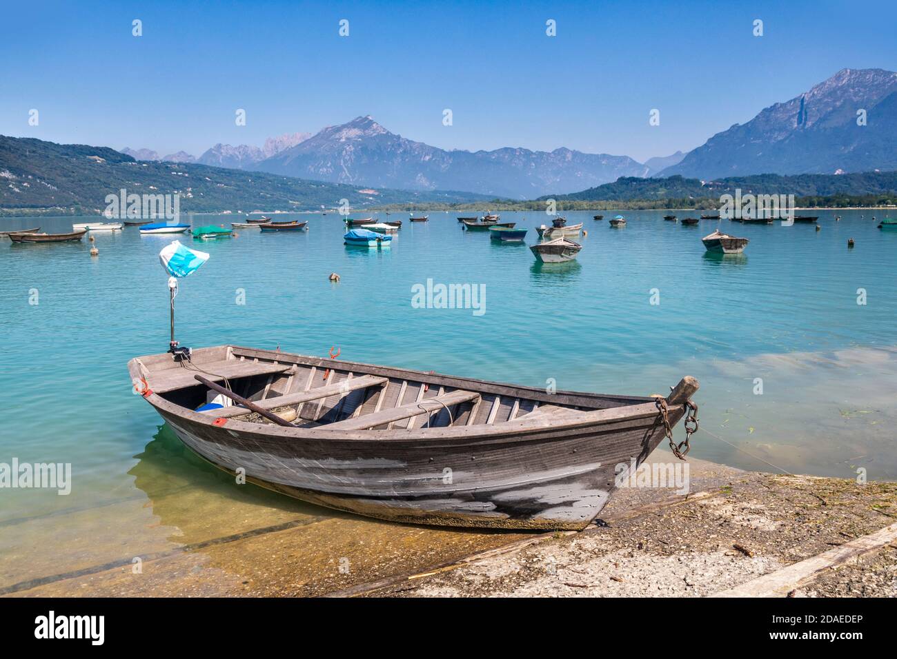 fishermen boats anchored to the poiatte, lake of santa croce, farra d'Apago, alpago, belluno, veneto, italy Stock Photo