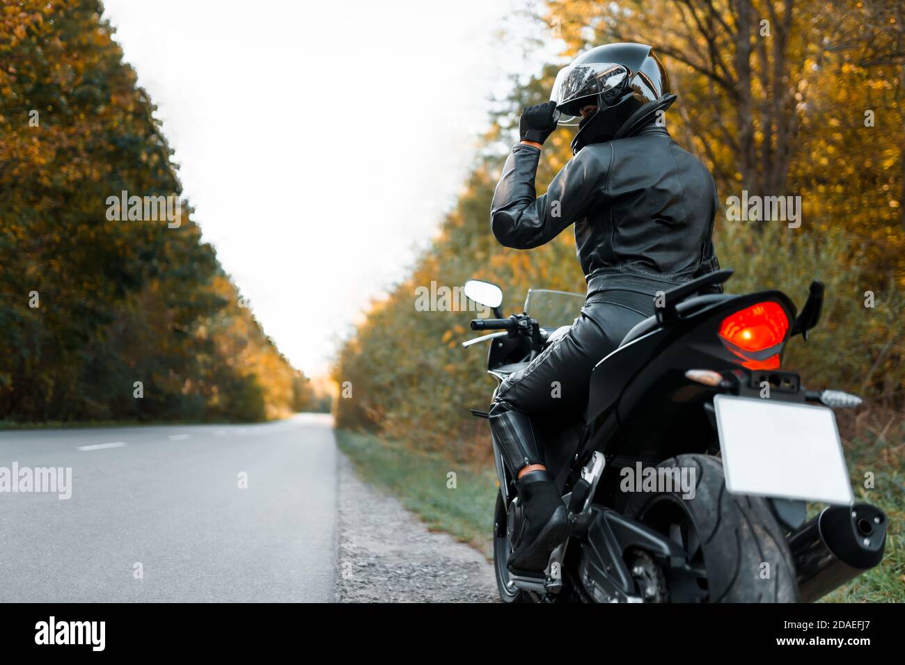 Motorcyclist in leather outfit on the roadside Stock Photo Alamy