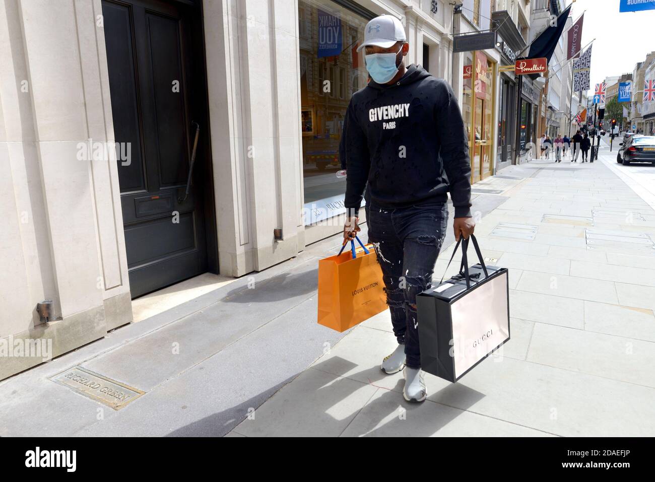 London, England, UK. Shopping in the West End during the COVID pandemic, August 2020. Man wearing torn and paint-splattered jeans with designer label Stock Photo