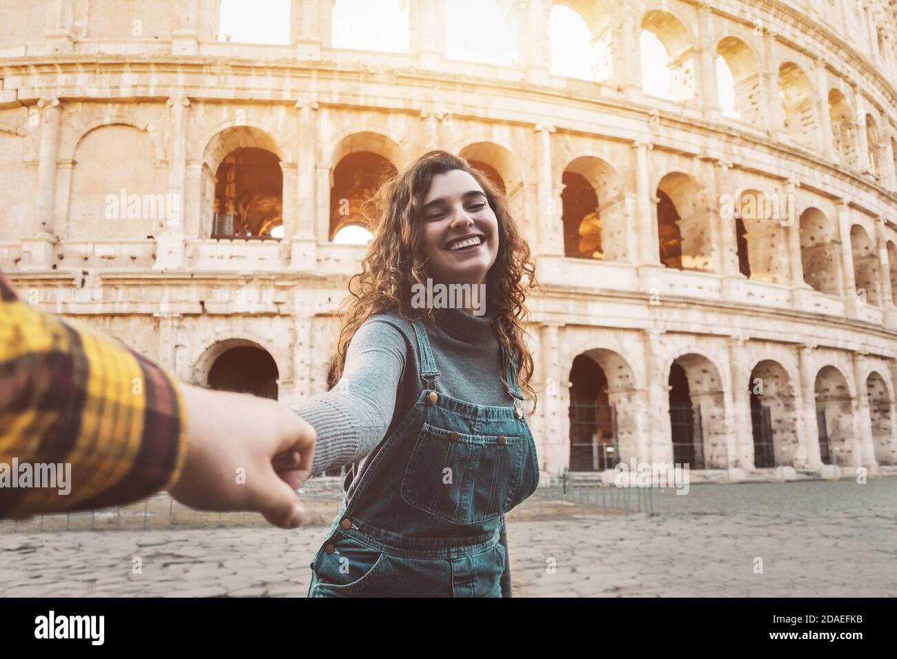 Young couple having fun together in Rome Colosseum - Happy lovers romantic moments during vacations in Italy Stock Photo