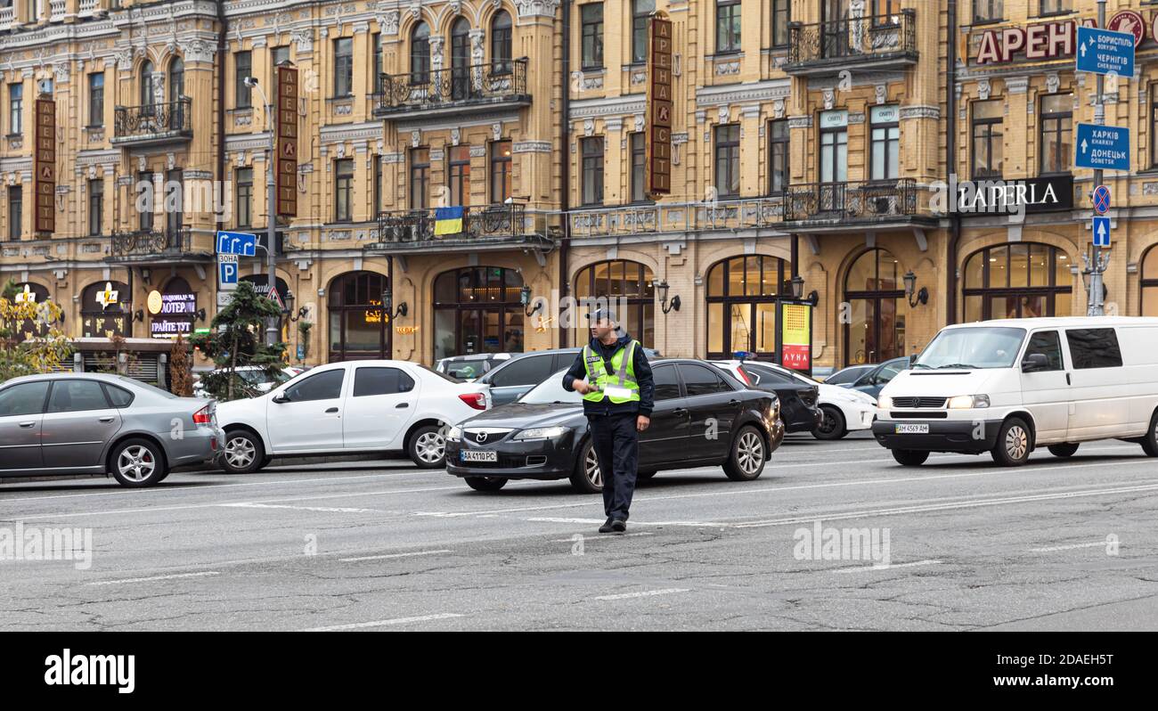 KYIV, UKRAINE - Sep 27, 2019: Street scene in Kyiv, the capital of Ukraine. A policeman regulates traffic in the center of Kiev on Khreshchatyk street Stock Photo