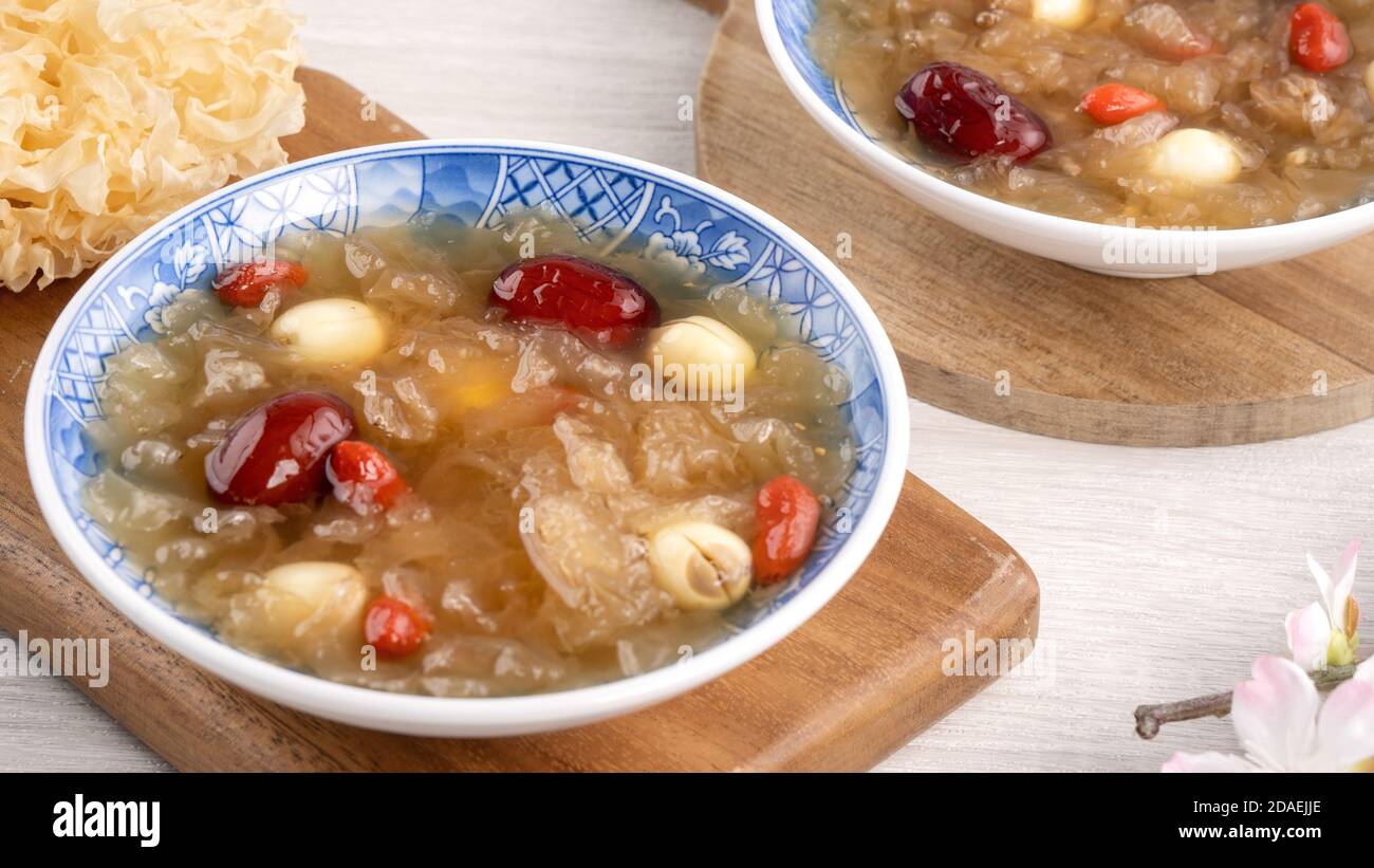 Close up of traditional Chinese sweet snow white fungus soup with lotus seed, red dates (jujube) and wolfberry (goji berry, gojiberry) on white backgr Stock Photo