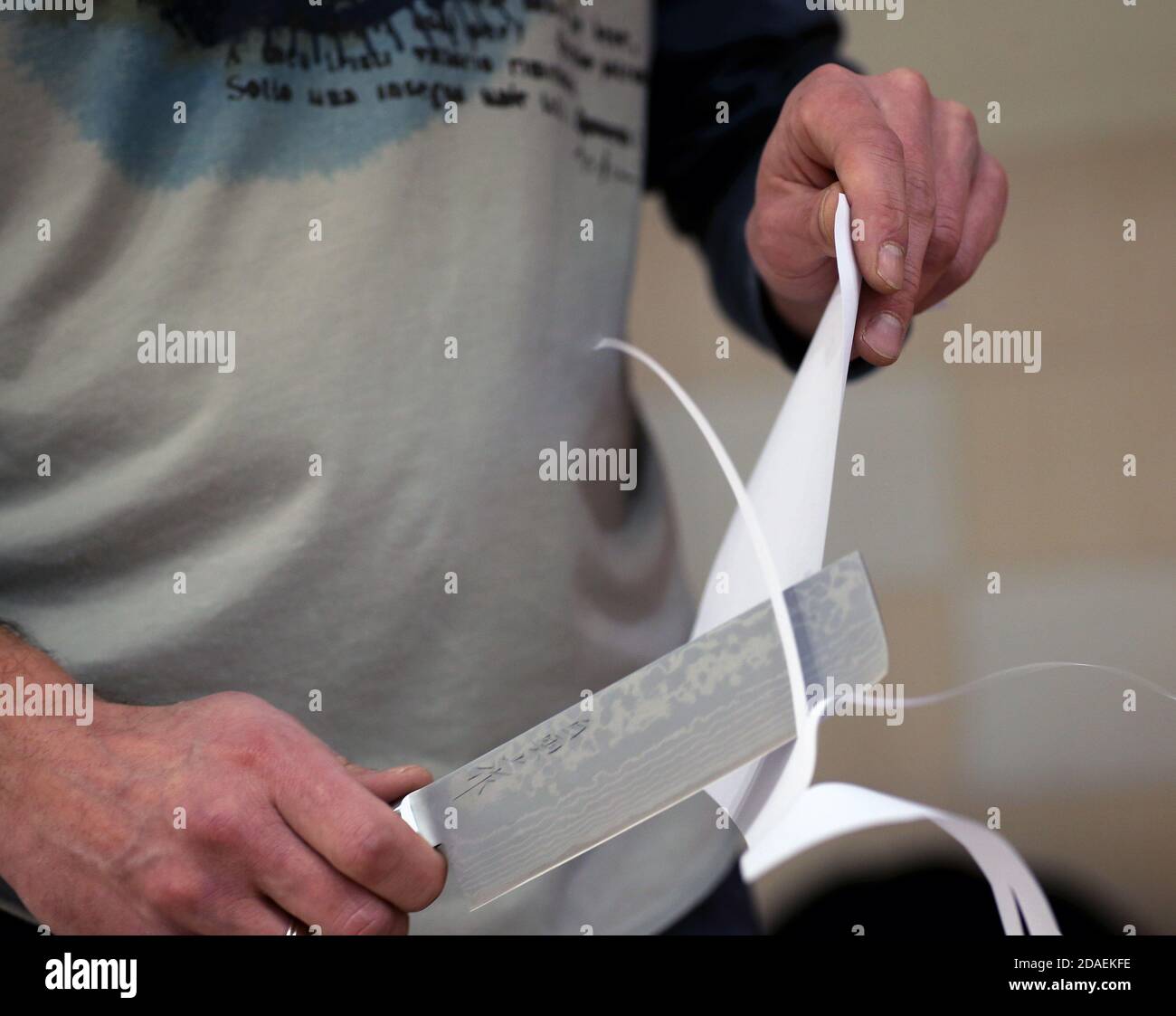 Knife sharpener and hand with blade Stock Photo - Alamy