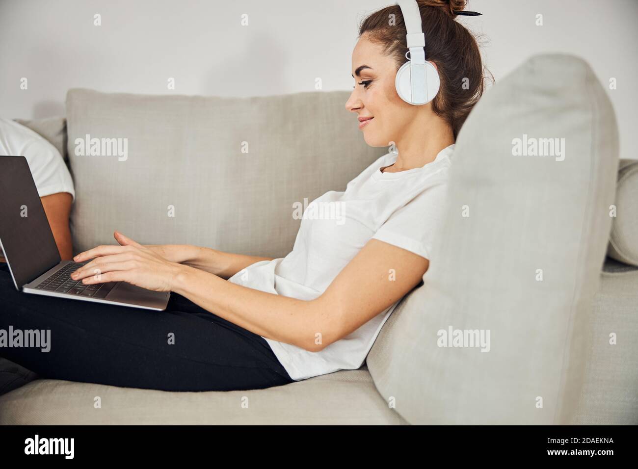 Beautiful lady in headphones working on her laptop from home Stock ...