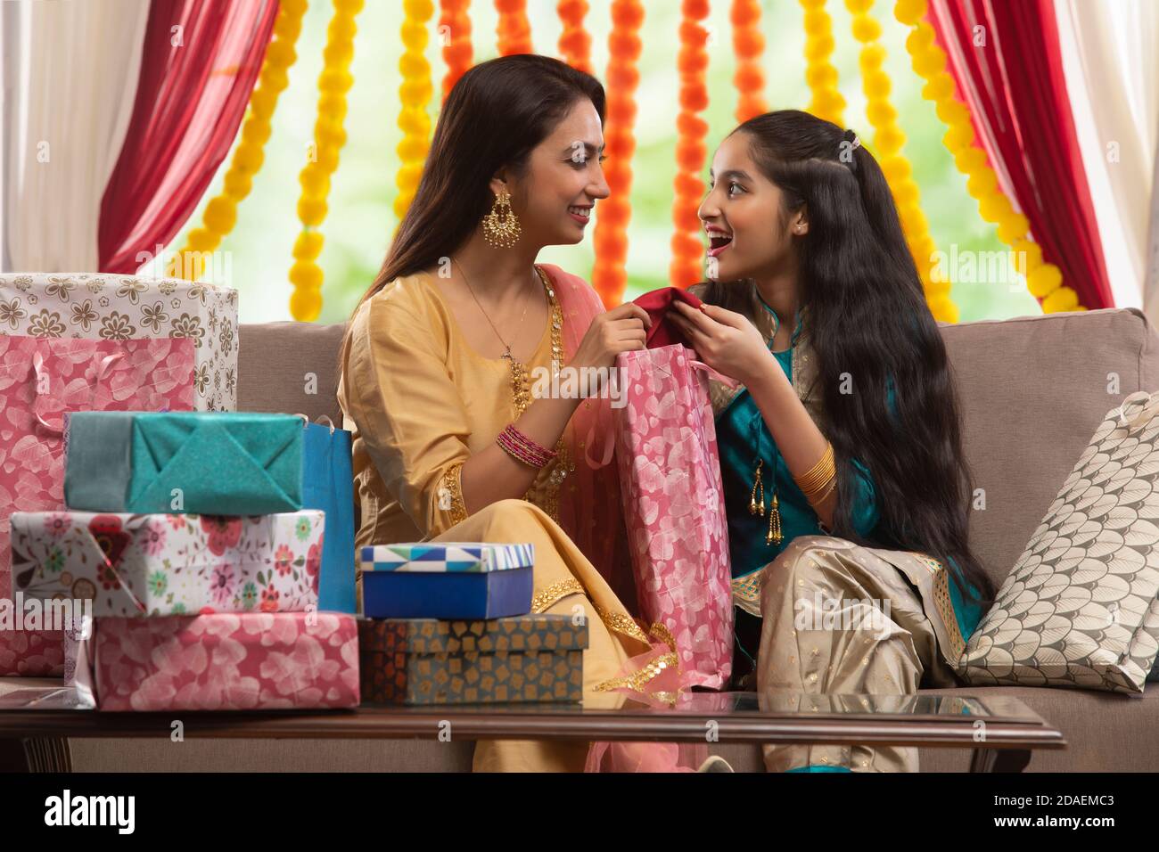Mother and daughter opening gifts together Stock Photo