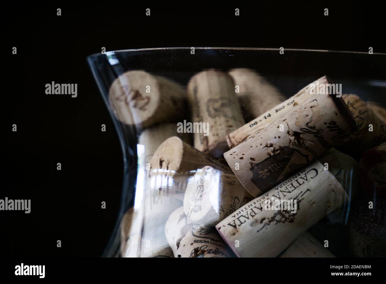 Wooden wine corks in a glass container Stock Photo