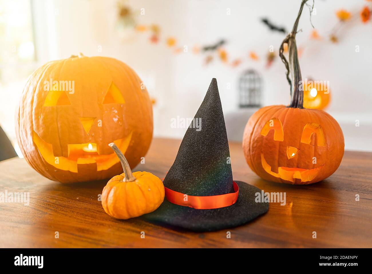 Halloween with pumpkins and witch hat on kitchen table Stock Photo - Alamy
