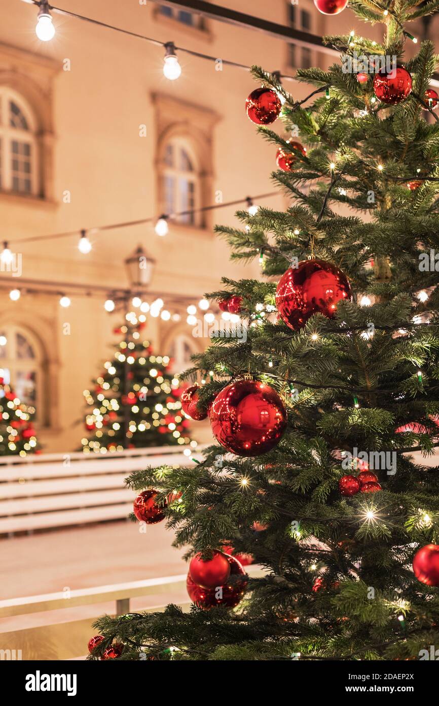 Christmas tree with red balls on a blurred city background, decorated ...