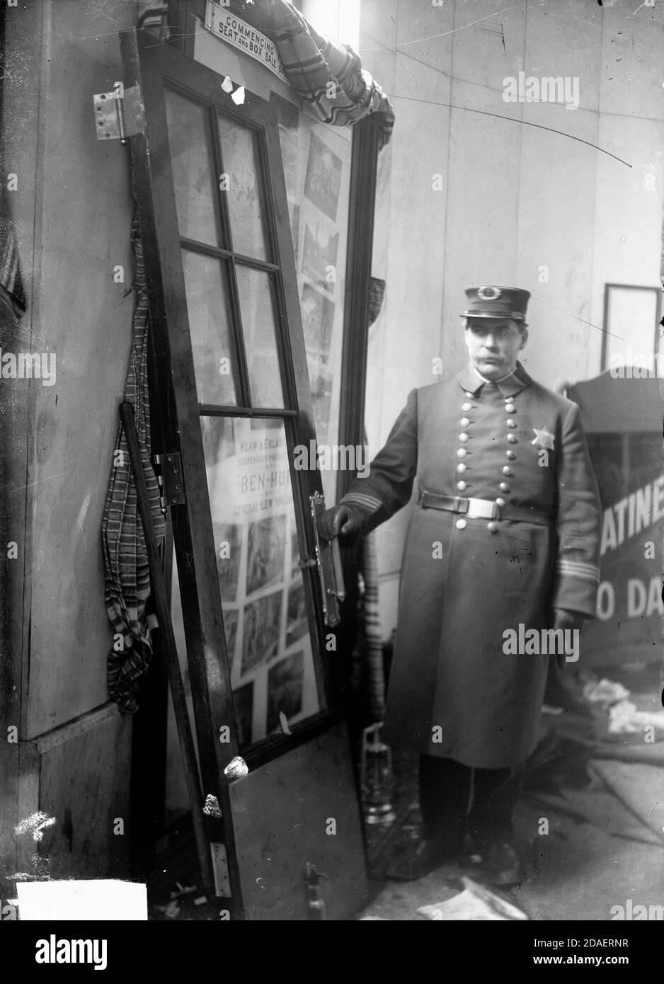 Portrait of a male police officer standing next to a door from the Iroquois Theater, Chicago, Illinois, December 30, 1903. Stock Photo