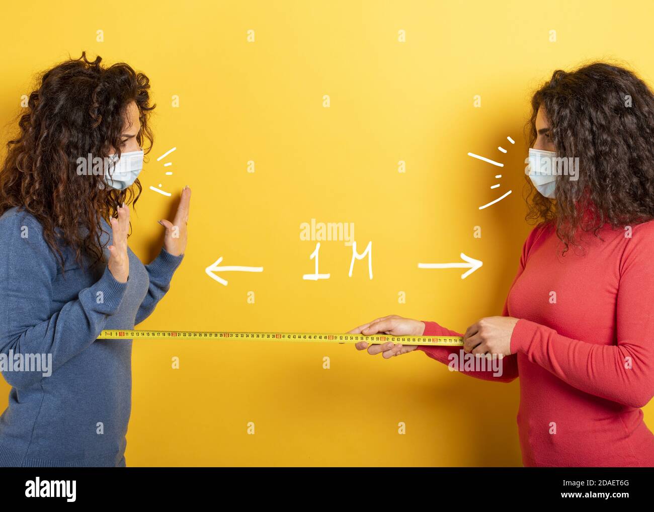 Friends keep distance between them of 1 meter. Concept of codiv-19 rules to avoid pandemic. yellow background Stock Photo