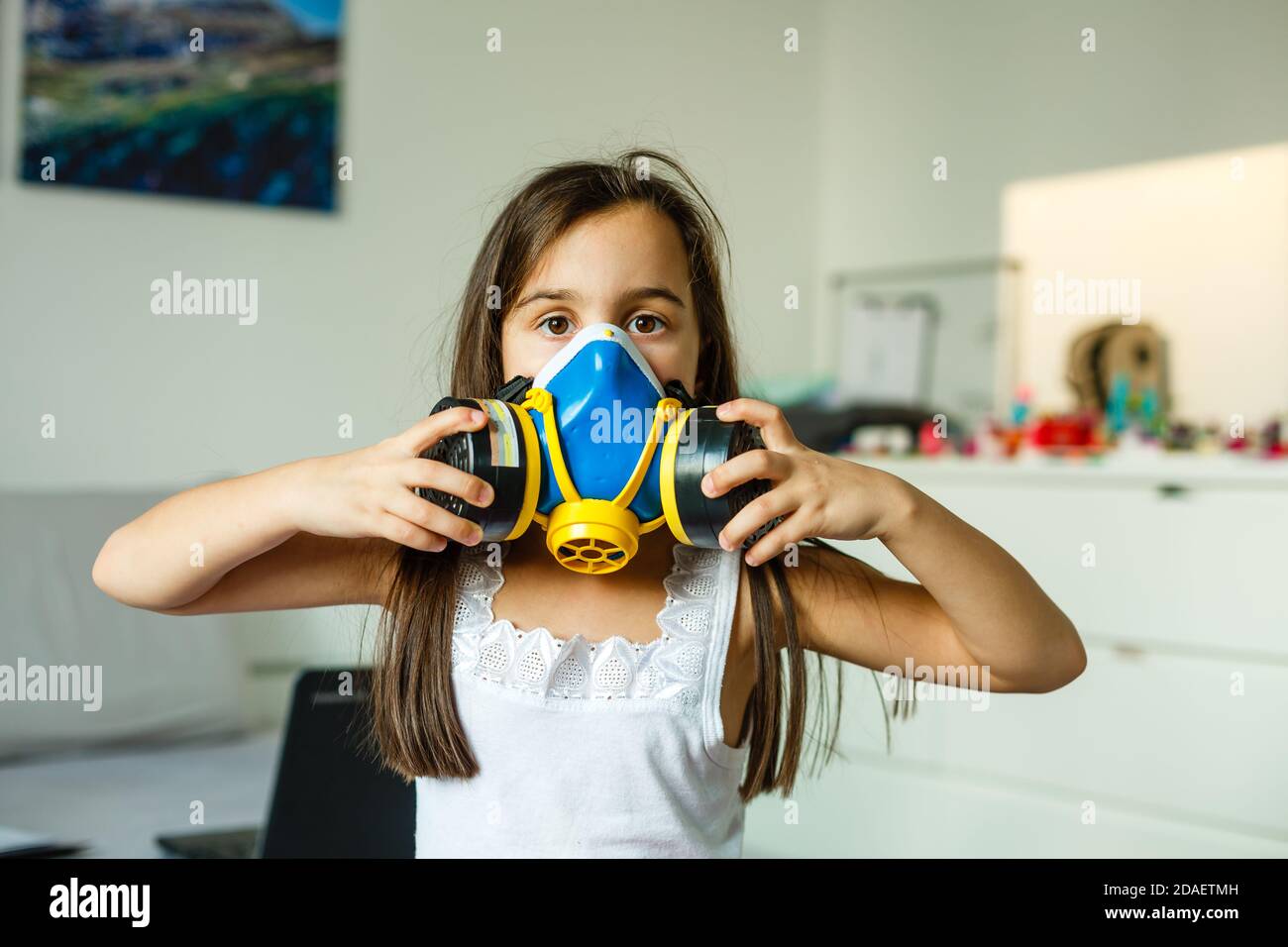 little girl in a big protective mask Stock Photo