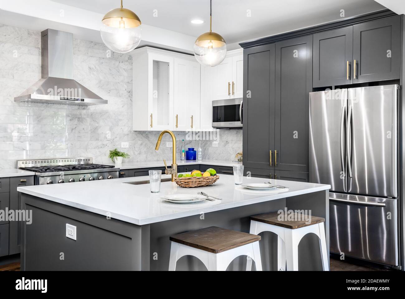 A luxurious white and grey kitchen with gold hardware, Bosch and ...