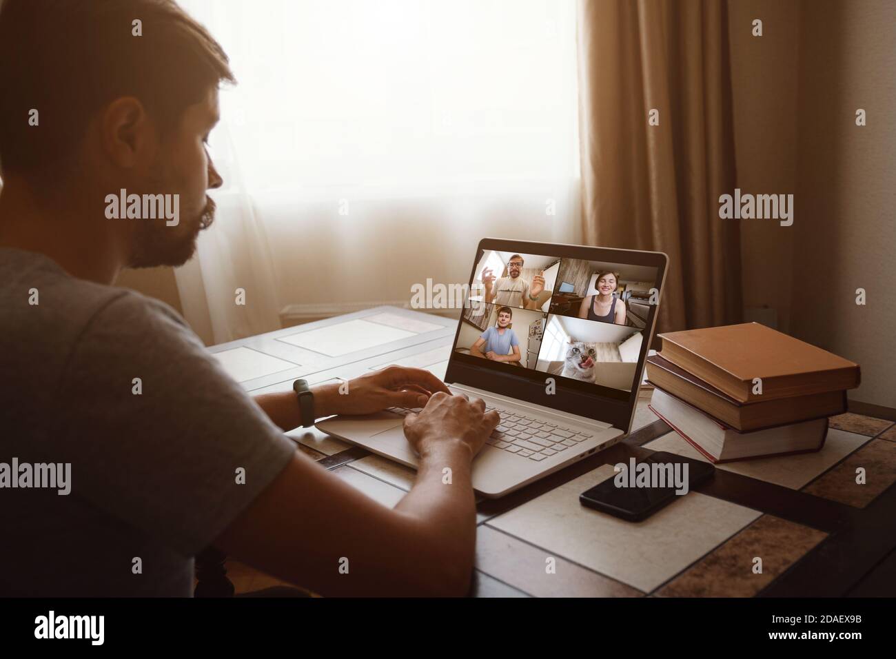 Back view of man talking to his colleagues about plan in video ...
