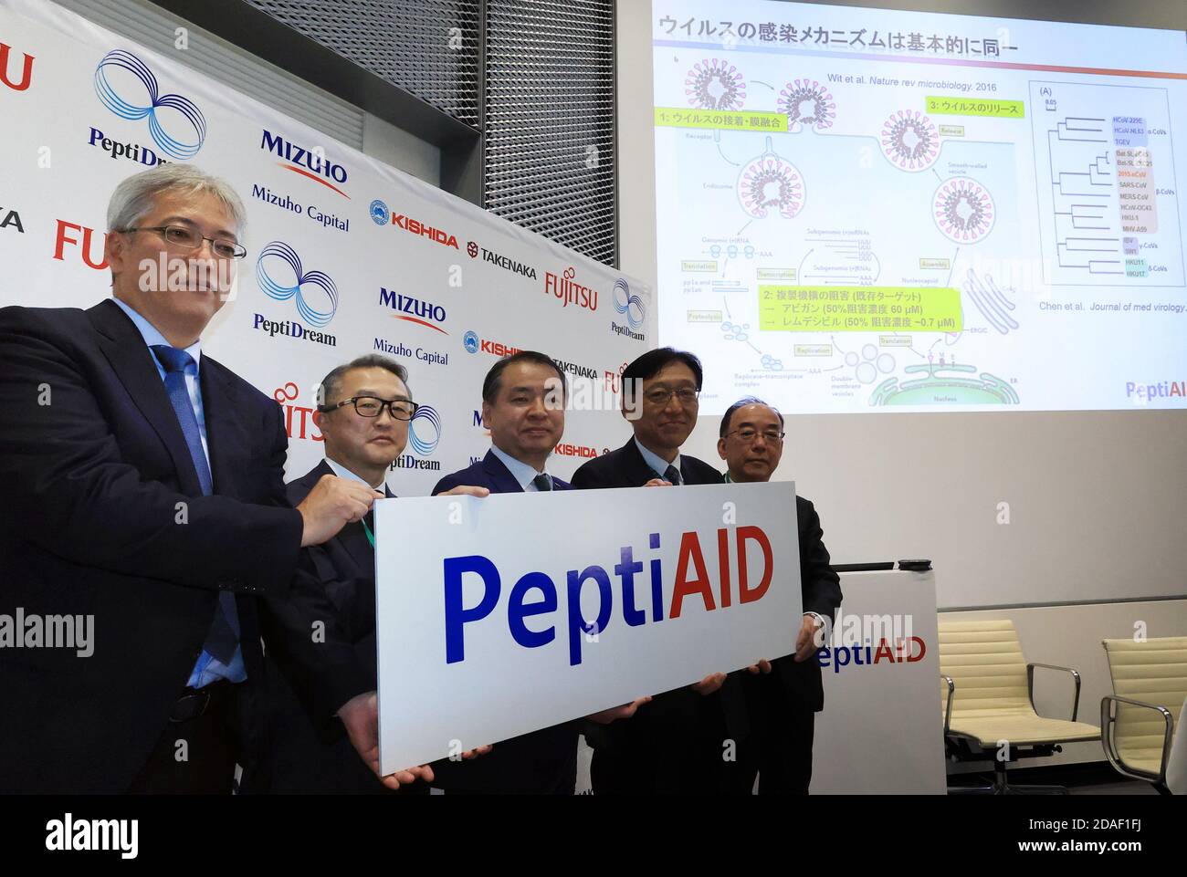 Kawasaki, Japan. 12th Nov, 2020. Japan's drug design venture PeptiDream vice president Keiichi Masuya (L) smiles with executives from Fujitsu, Mizuho Capital, Takenaka Corp and Lishida Chmical as he announces PeptiDream will form a joint venture PeptiAID with four companies to development of the new drug for the treatment of COVID-19 at the company's headquarters in Kawasaki, suburban Tokyo on Thursday, November 12, 2020. PeptiDream developed PDPS technology to find peptide candidates targeting spike protein of coronavirus to enter human cells. PeptiAID will obtain PeptiDream's COVID-19 c Stock Photo