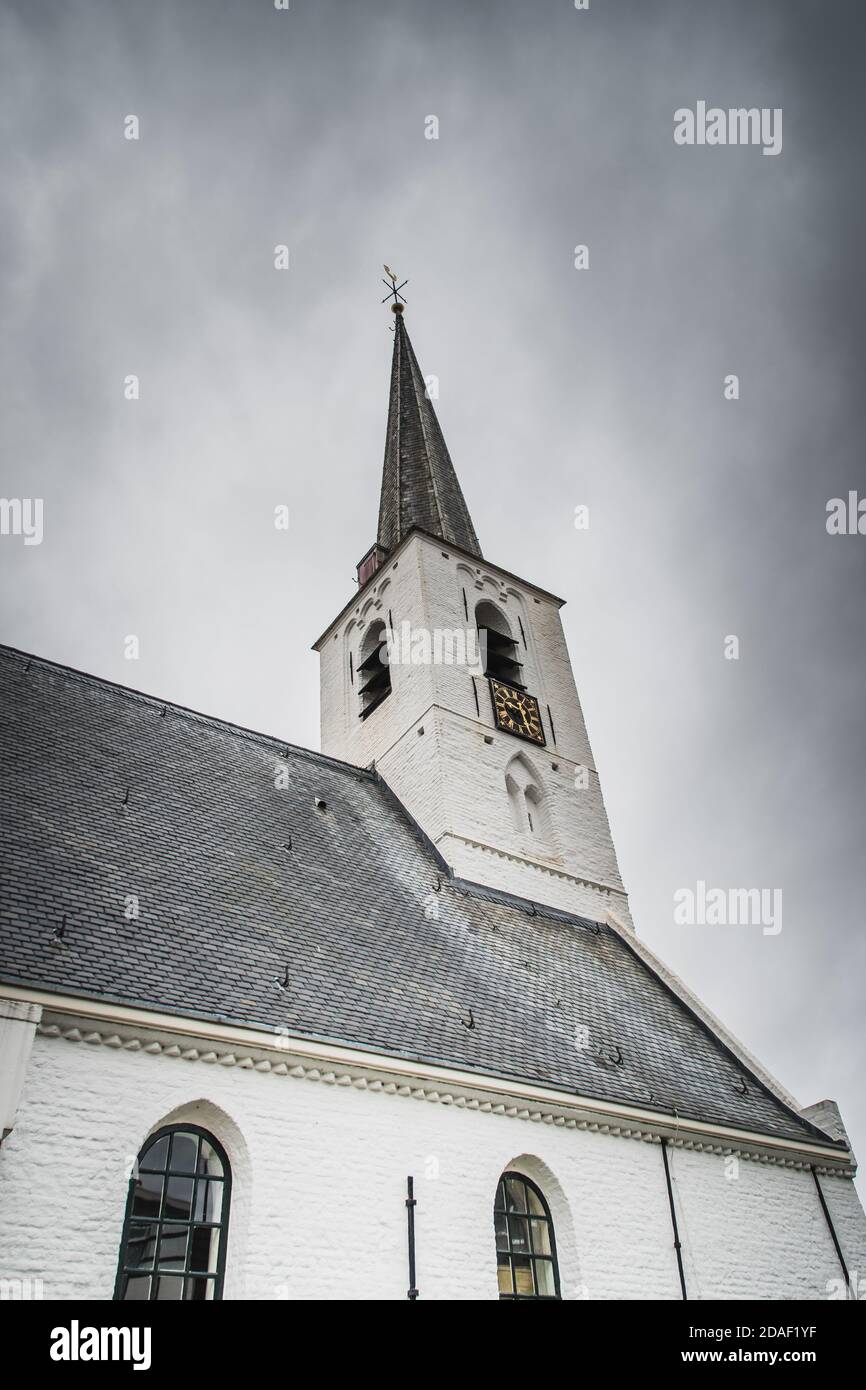 White church in Noordwijkerhout in the Netherlands with cloudy sky Stock Photo