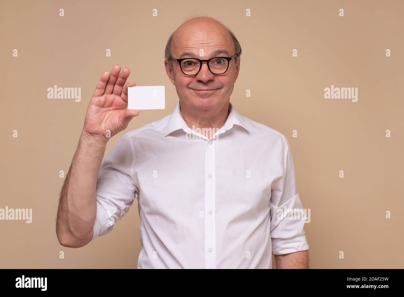 Senior caucasian man holding blank visiting card Stock Photo