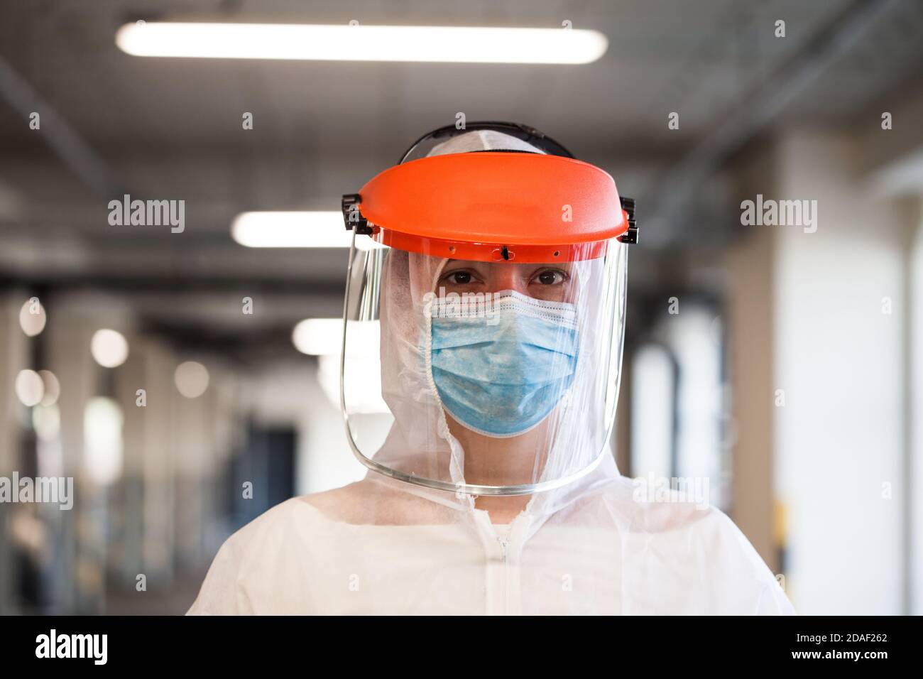 Coronavirus COVID-19 virus disease global pandemic outbreak,UK NHS frontline medical key worker,EMS Personal Protective Equipment,parking lot hallway, Stock Photo