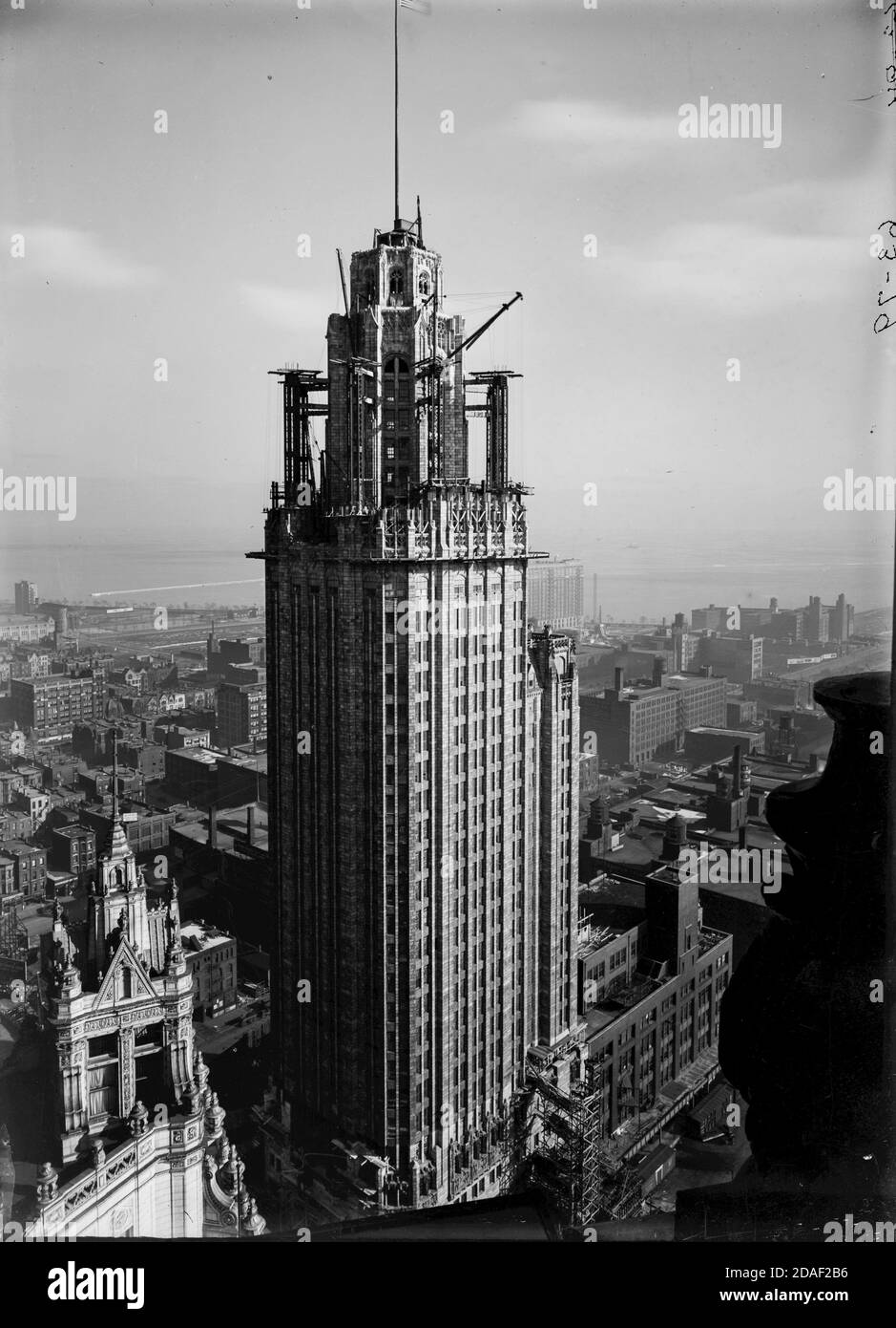 Elevation of Tribune Tower showing construction of uppermost stories, architect Howells and Hood, Chicago, Illinois, circa 1925, circa 1925-1936. Stock Photo