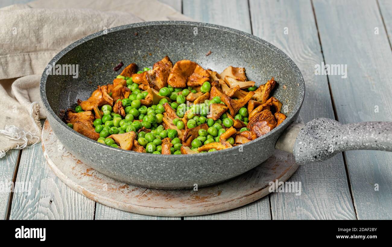 Food banner. Fried chanterelles with vegetables in a pan. Edible