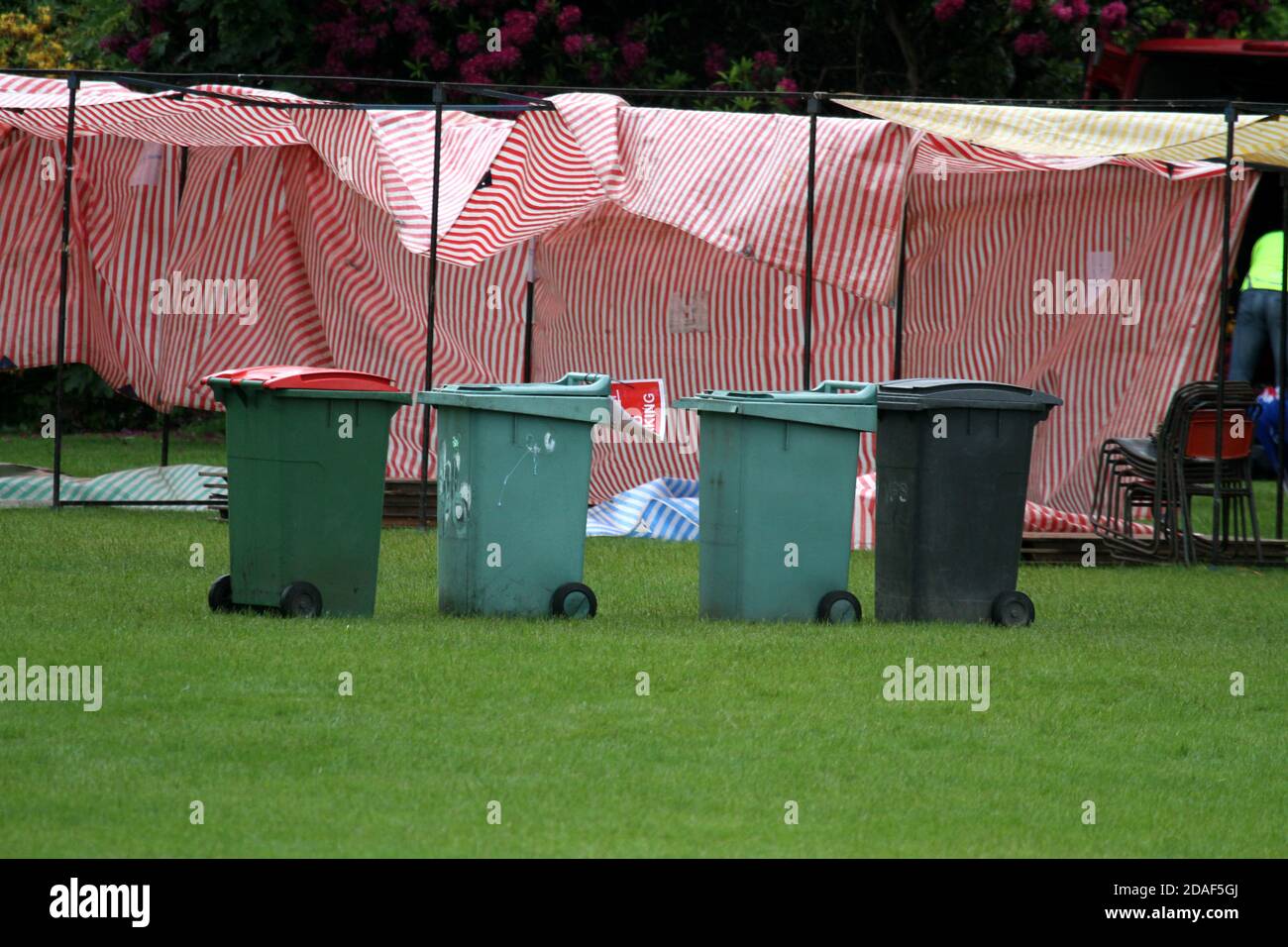 Empty market stalls and wheelie bins in field on a wet day Stock Photo
