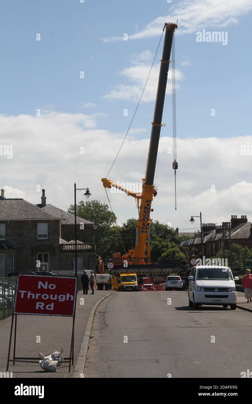New Bridge being installed on Station Road, Prestwick, South Ayrshire, Scotland using heavy lifting equipment Stock Photo
