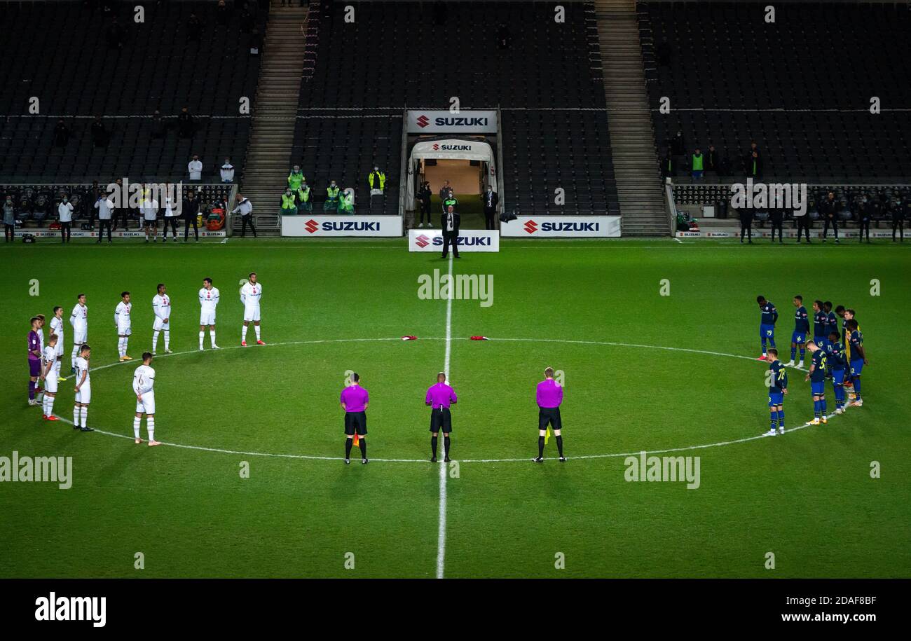 Players, staff and officials stand to remember armed forces members who have died in the line of duty during the EFL Trophy ' match played behind closed doors between MK Dons and Southampton U21 at stadium:mk, Milton Keynes, England on 11 November 2020. Photo by Andy Rowland. Stock Photo