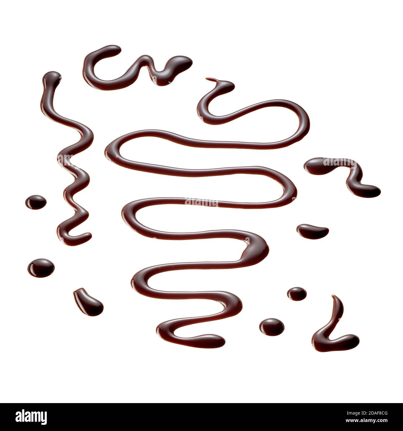 Decorative wavy drizzles, drops and splatters of chocolate sauce isolated on white for use in food styling concepts or advertising Stock Photo