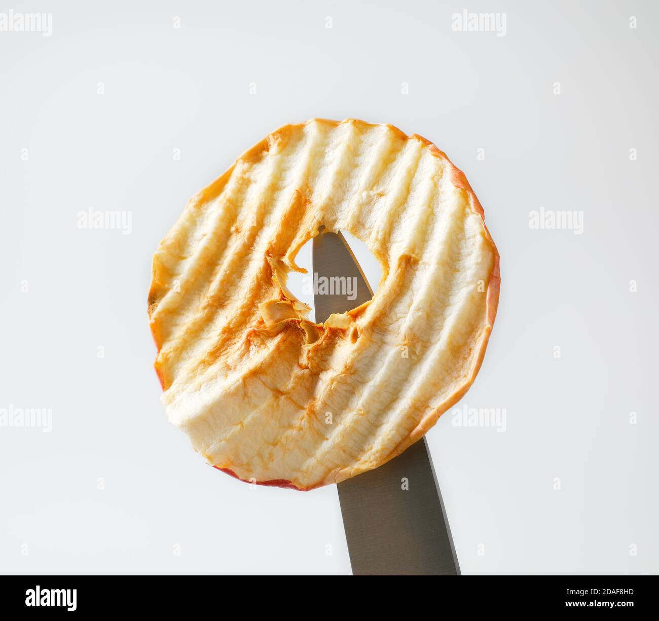 One apple chip on tip of a knife Stock Photo