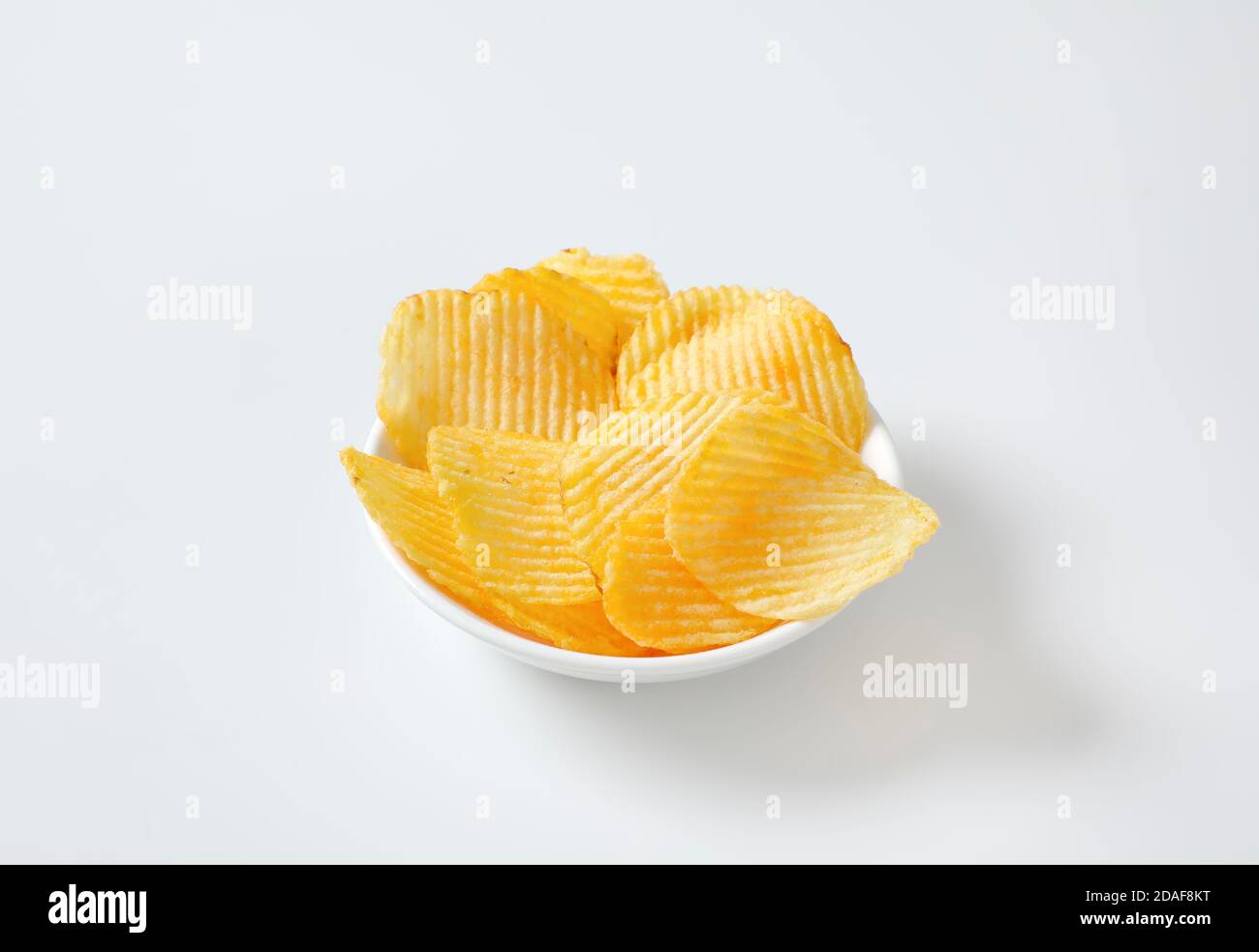 Bowl of thin ridged potato chips Stock Photo