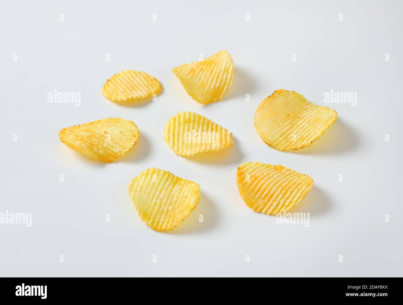 Six thin ridged potato chips Stock Photo