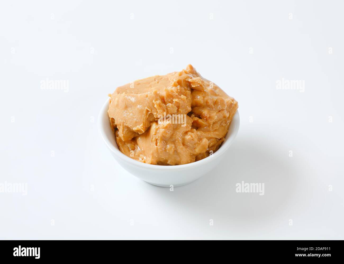 Crunchy peanut butter in white bowl Stock Photo