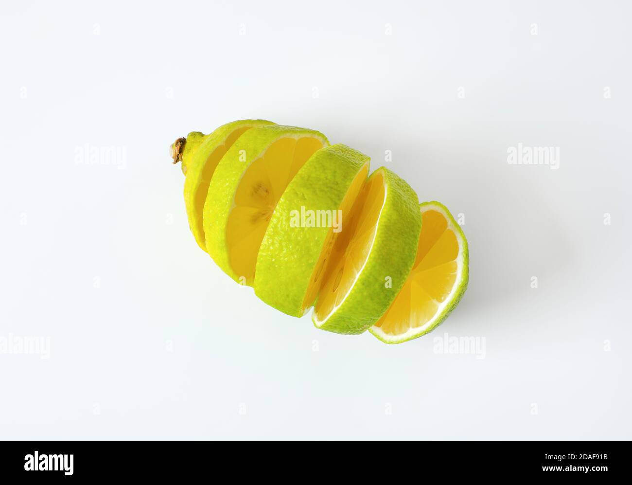 Lemon with green peel and yellow flesh, sliced Stock Photo