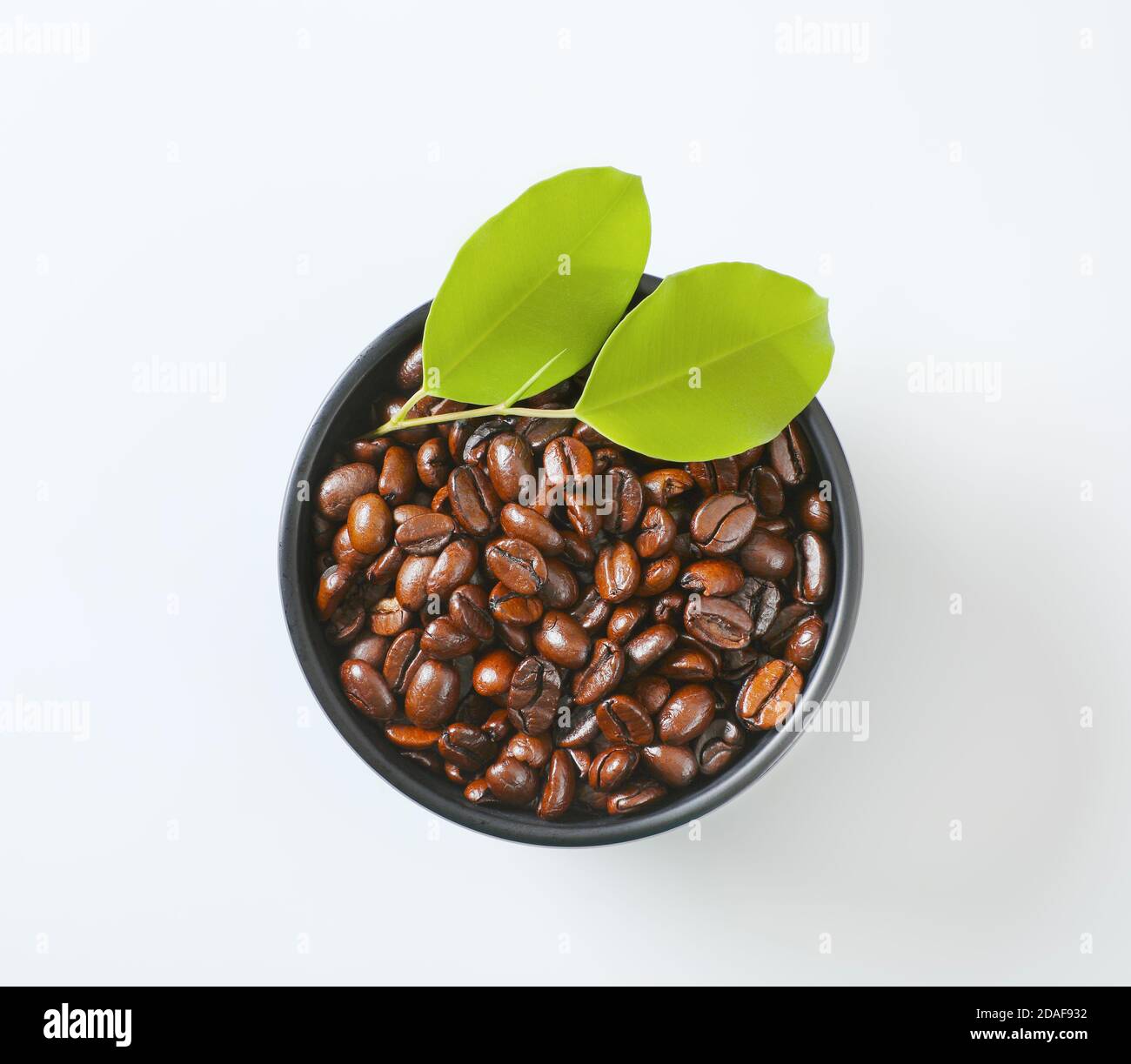 Roasted coffee beans in black bowl Stock Photo