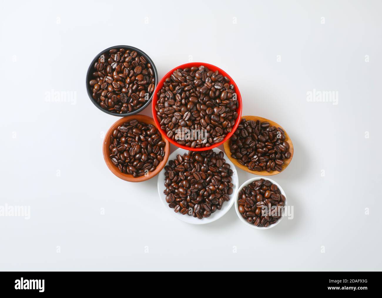 Roasted coffee beans in various bowls and on plate Stock Photo